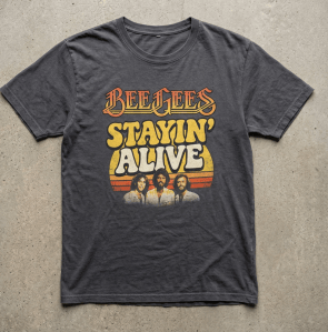 Laughing man at a festival wearing a Beatles Stayin’ Alive graphic T-shirt